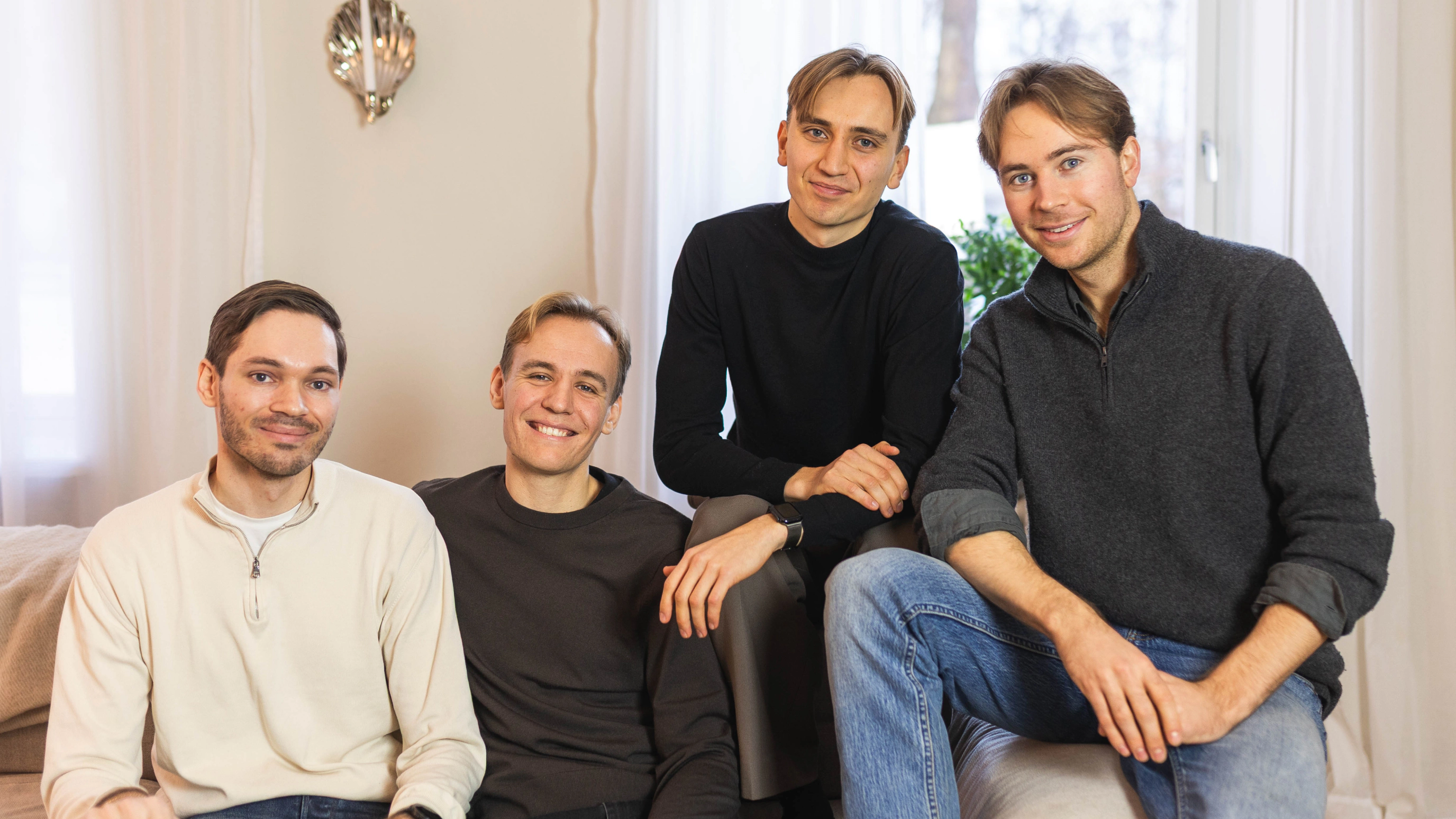 Stilta co-founders Tobias Estreen, Petrus Werner, Oskar Block, and Oscar Adamsson seated together in a bright living room.